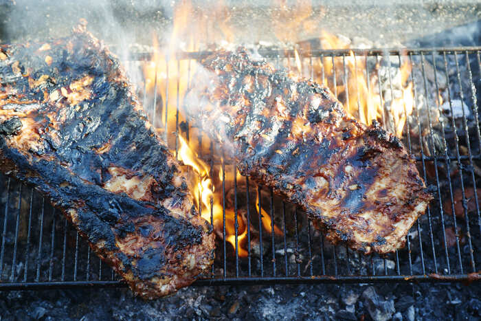 Ribs cooking over open flames