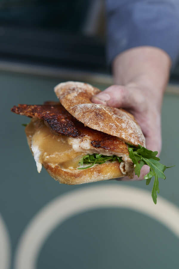 The signature Roast Hog porchetta roll with crackling and rocket